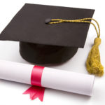 A graduation cap with a gold tassel is placed next to a rolled diploma tied with a red ribbon on a white surface.