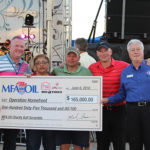 Mark Fenner, MFA Oil president and CEO, presents a $165,000 check to Operation Homefront during MFA Oil's Annual Charity Golf Scramble & Concert.