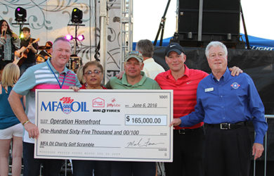 Mark Fenner, MFA Oil president and CEO, presents a $165,000 check to Operation Homefront during MFA Oil's Annual Charity Golf Scramble & Concert.