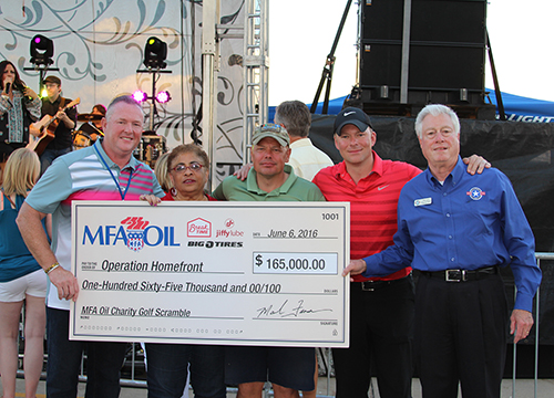 Mark Fenner, MFA Oil president and CEO, presents a $165,000 check to Operation Homefront during MFA Oil's Annual Charity Golf Scramble & Concert.
