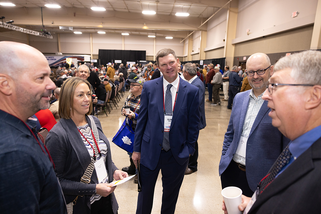 MFA Oil Board Chairman Glen Cope is conversing with a group of delegates, peers and industry guests.