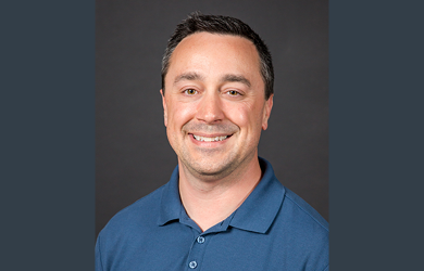 Adam Buckallew, MFA Oil Member Relations Manager, is wearing a blue polo shirt, against a dark neutral background.