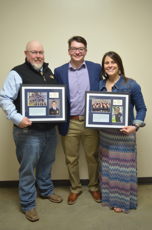 Doug Henke (left) and Deanna Schnuck (right), Boonslick Technical Education Center agricultural education instructors and FFA advisors, hold plaques honoring the service of Tyler Schuster (center), a retired Missouri FFA state officer. Such gifts are often presented to FFA advisors at the Missouri FFA State Convention.