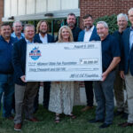 Ten people stand outdoors, smiling and holding a large ceremonial check for $30,000 made out to the Missouri State Fair Foundation from MFA Oil, dated August 6, 2025.