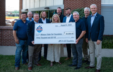 Ten people stand outdoors, smiling and holding a large ceremonial check for $30,000 made out to the Missouri State Fair Foundation from MFA Oil, dated August 6, 2025.