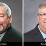 Two professional headshots. Left: A man with gray hair and a beard in a suit, smiling. Right: A man with short gray hair and glasses in a suit, smiling. Names under each: Mike Moreland (left) and Randy Pace (right). Gray background.