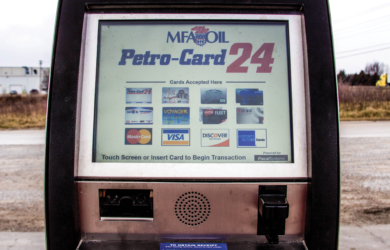 A fuel pump display showing the Petro-Card 24 service. The screen lists accepted cards, including MasterCard, Voyager, Wright Express, Visa, and Discover. Instructions prompt users to touch the screen or insert a card to start a transaction.